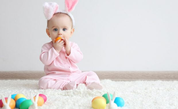 a baby sitting on safely cleaned carpet during easter